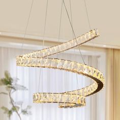 a modern chandelier hanging from the ceiling in a living room or dining room