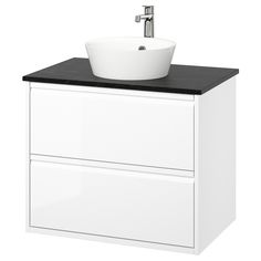 a white sink sitting on top of a cabinet