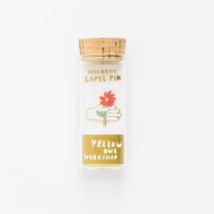 a bottle with a label on it that says, authentic lapel - pin yellow pine wax