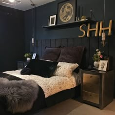 a bed room with a neatly made bed and some pictures on the wall above it