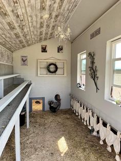 the inside of a building with several items hanging from the ceiling and windows on the wall