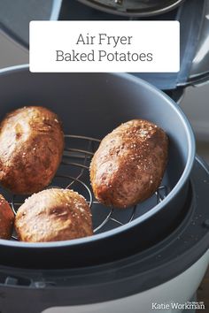 four baked potatoes in an air fryer with the words air fryer baked potatoes