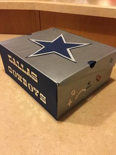 a cardboard box with the cowboys logo on it