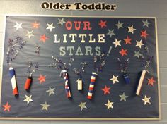 a bulletin board with stars and fireworks on it that reads our little stars, older toddler