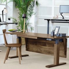 a wooden desk sitting in front of a computer monitor