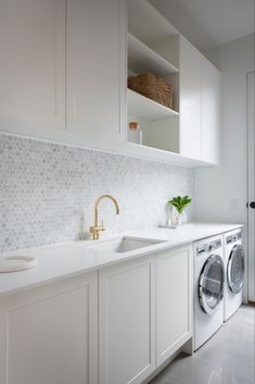 a washer and dryer in a white laundry room