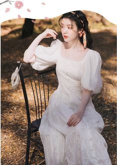 Contemplate the Ending of Summer in this beautiful white Light Academia Dress from Deer Doll featuring voluminous balloon sleeves allowing an off-the-shoulders look, faux buttons through front, tiered layers and intricately romantic fabric embroidery. Elegant Spring Peasant Dress With Puff Sleeves, White Square Neck Dress With Buttons, White Vintage Off-shoulder Dress, White Off-shoulder Vintage Dress, Vintage White Off-shoulder Dress, Feminine White Puff Sleeve Dress, White Puff Sleeve Dress With Gathered Billowy Sleeves, White Billowy Puff Sleeve Dress With Gathered Sleeves, Billowy Puff Sleeve Peasant Dress