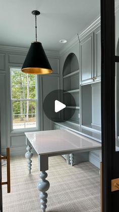 a kitchen with a table and cabinets in it