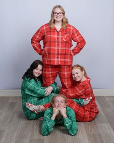 three people in red and green pajamas posing for a photo