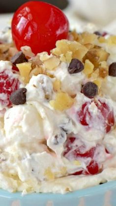 an ice cream sundae with chocolate chips and cherries on top, topped with a cherry