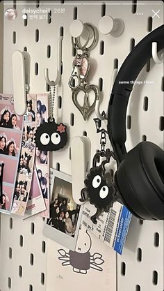 there are many different items hanging on the pegs in this room, including headphones and pictures