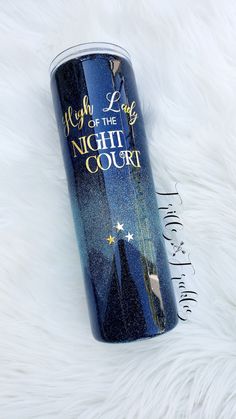 the night court tumbler is sitting on a fluffy white surface