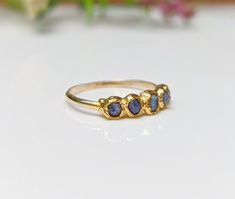 What's not to Love about this raw Sapphire Eternity ring ! Our September Birthstone ring features a row of 5-7 small raw blue Sapphires uniquely handcrafted on a Solid 14k Gold filled band. This lovely raw multi-stone ring will make a unique wedding band, but can also be offered as a gift on special occasions such as a birthday, anniversary, Mother's Day, Christmas, or Valentine's Day and would surely make a lovely alternative engagement ring! ❣T H E ∙ S M A L L ∙ D E T A I L S• 5-7 raw blue Sap Raw Sapphire, September Birthstone Ring, Birthstone Ring Mothers, Sapphire Eternity Ring, Unique Wedding Band, Raw Stone Jewelry, September Birthstone Rings, Alternative Engagement Ring, Unique Wedding Bands