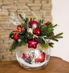 a glass bowl filled with ornaments on top of a table