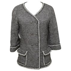 GUARANTEED AUTHENTIC CHANEL 2014 SPRING COLLECTION METALLIC FANTASY TWEED DOUBLE BREAST JACKET Retailed excluding sales taxes $4,920. Details: • Double breast jacket in a silver metallic fantasy tweed. • Collarless. • V-neck. • Front flap pockets. • 3/4 sleeves. • Fully lined with silver chain at hem. • Comes with extra fabric swatch and button. Fabric: 74% Polyamide, 26% Polyester; 100% Silk Lining. Size: 40 Measurements (Approximate Laid Flat): • Shoulder to Shoulder: 18" • Underarm to Underarm: 18.5" • Sleeve Length: 16.5" • Total Length: 25.5" (tip of rear neckline to bottom front center hem) To Our Customers: - We consider it a privilege to serve as your luxury fashion concierge. Whether you are looking to buy that special one-of-a-kind item, (that no one else can find), scoring a spe Chanel 2014, Designer Jackets For Women, Chanel Tweed Jacket, Chanel Tweed, Chanel Jacket, Crochet Trim, Cc Logo, Jacket Design, Environmental Impact