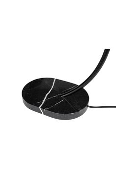 a black and white photo of a cord connected to a cell phone with a marble design on it