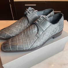 These Are Rare, Genuine Alligator Shoes, Hand Made In Italy, In Gently Used Condition. Color- Light Grey. Size 10 Us, However They Run Large, More Like A 10.5 Or 11. Shoes Will Come In Their Original Box. They've Been Stored In The Box With Shoe Trees Since Purchase So They've Maintained Excellent Shape. The Alligator Skin Material Is Super Soft And Supple. There Are Signs Of Wear On The Bottom Leather Soles, However No Obvious Signs Of Wear Anywhere Else. Alligator Shoes, Alligator Skin, Shoe Tree, Color Light, Alligator, Derby, Light Grey, Original Box, Men's Shoes