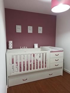 a baby's room with a crib and dresser