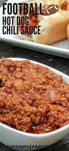 two plates with hot dogs and chili sauce on them, one is in the foreground