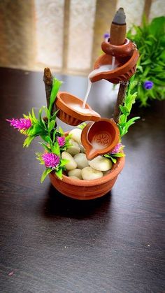 a wooden bowl filled with rocks and flowers