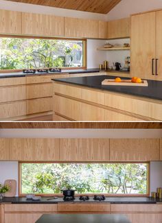 The kitchen includes a horizontal window above the cooktop, offering views of mature rhododendrons, as well as plain-sawn Ash cabinetry and Basaltina Natural Stone countertop with a honed finish. Wood Bathtub