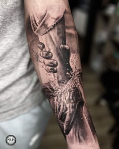 a man's arm with a black and white tattoo on it