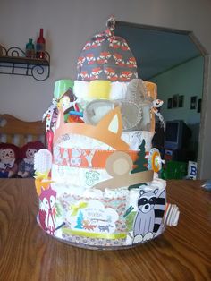 a baby's diaper cake sitting on top of a wooden table