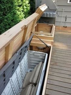 an empty boat is sitting on the deck next to a fenced in backyard area