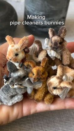 small stuffed animals sitting on top of each other in someone's hand with the caption making pipe cleaners bunnies