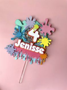 a cake topper with the number four on it and some sprinkles