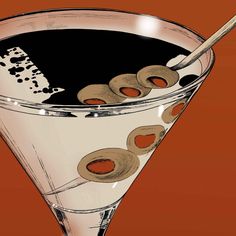 a martini glass with olives in it and a spoon sticking out of the top