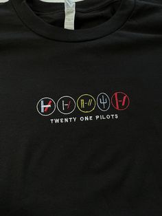 a black t - shirt with the words twenty one pilots printed on it