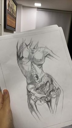 a person holding up a drawing in their hand