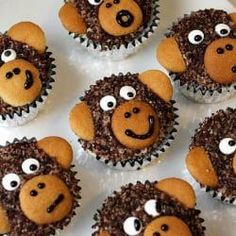 twelve cupcakes with brown frosting and eyes on them are arranged in the shape of a monkey