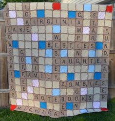 a blanket with words written on it sitting in the grass next to a wooden fence