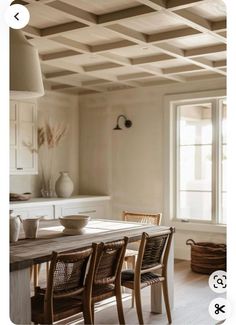 a dining room table with four chairs around it