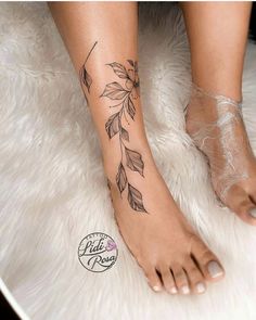 a close up of a person's foot with leaves on it