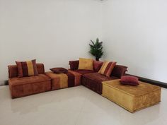 a couch and ottoman in a room with white walls