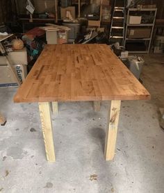 a wooden table sitting inside of a garage