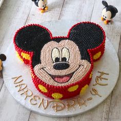 a mickey mouse birthday cake on a plate