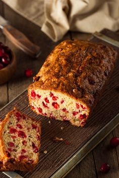 a loaf of cranberry bread sitting on top of a cutting board