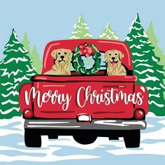 two dogs sitting in the back of a red truck with christmas wreaths on it