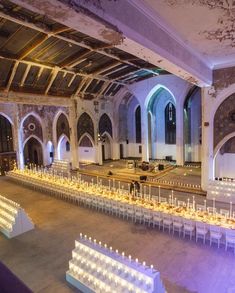 an empty banquet hall with rows of tables and chairs set up for a formal function