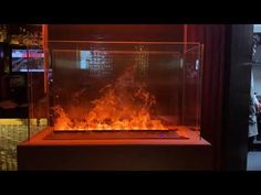 a fire is burning in a glass case