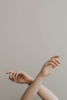 a woman's hand reaching up to catch a frisbee