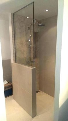 a walk in shower sitting inside of a bathroom