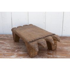 a wooden bench sitting on top of a wooden floor