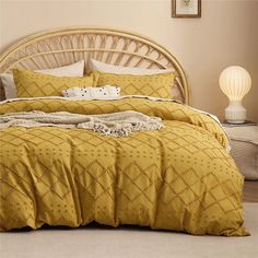 a bed with yellow comforters and pillows