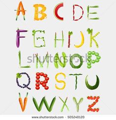 the alphabet with fruits and vegetables painted on it's sides, including carrots, grapes