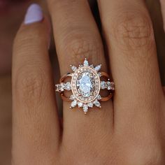 a woman's hand with an engagement ring and diamond set on top of it